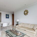 Living-dining area at this santorini condo with a table, couch, and table