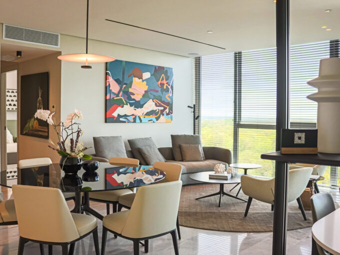 Image of living room with couch, table and chairs in this condo for sale in The Ivy