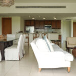 Image of the living area with a couch, table, and chairs at Altamar