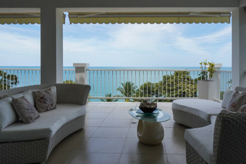 Image of terrace with chair, table and ocean view at Bijao