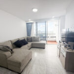 Image of living room with couch television and balcony in this condo for sale in this Mid-Floor Condo with Balcony in Luxor 400 El Cangrejo