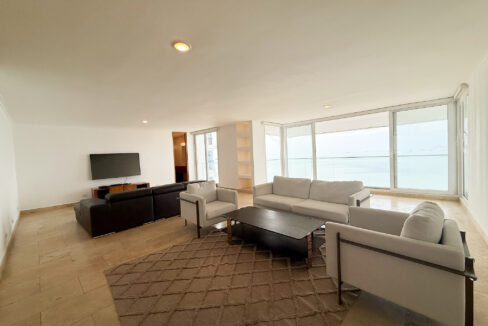 Image of living room with couch and table in this condo for rent in Mirador Marino