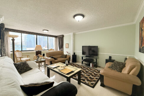 Image of living room with television, couch and table in this condo for sale in Monaco