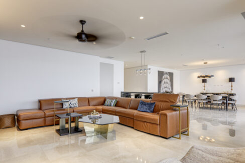 Image of living room with couch and table in this condo for sale in Matisse