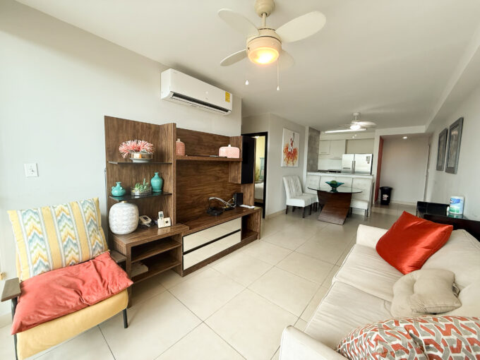 Image of living room with couch and chair in this condo for sale in Sole Tower