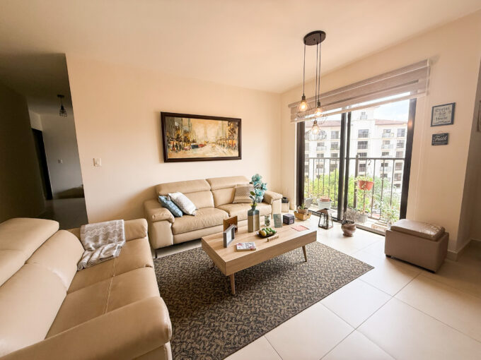 Image of living space with couch and table in this condo for sale in Embassy Village
