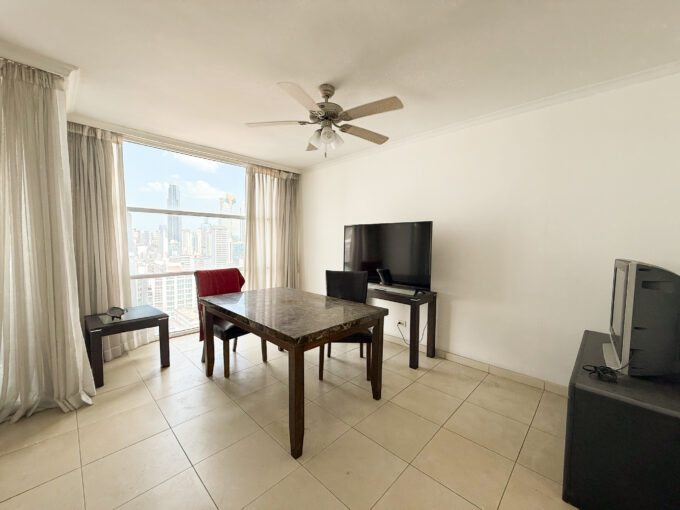 Image of living area with table and chairs in this condo for sale in Solaris