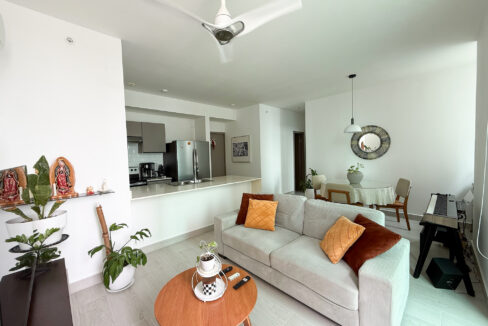 Image of living room with view of kitchen, coffee table and couch in this condo for sale in P.H Urbana