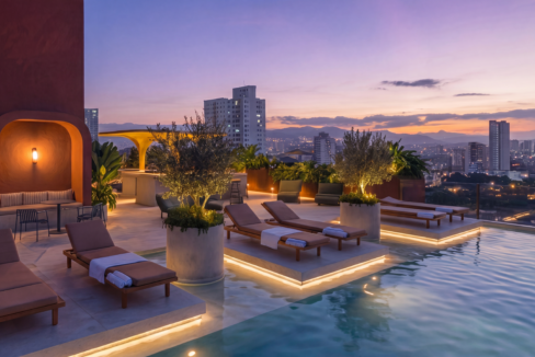 Selvatica’s infinity pool and loungers glowing at sunset beside the terrace bar and city skyline.